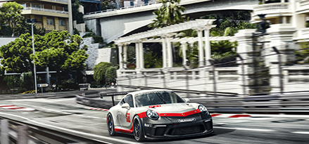 Porsche driving down street