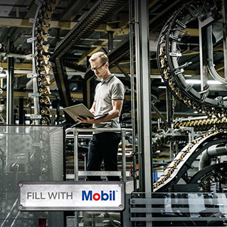 Machine shop's brochure cover - Mobil engineer standing with a computer in a factory 